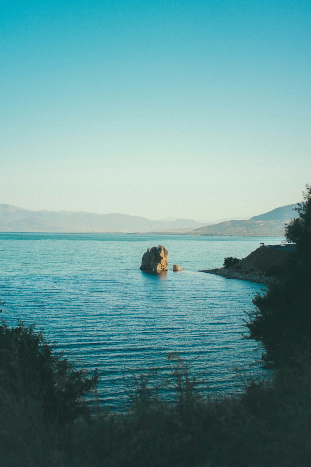 body of water under clear blue sky