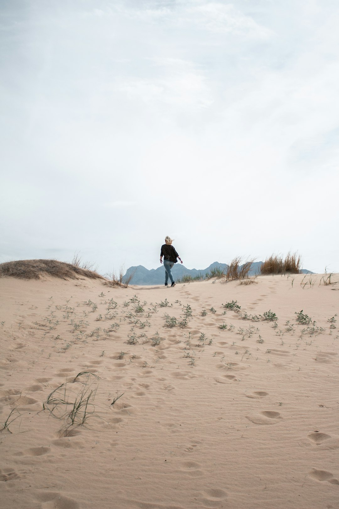 woman walking on sand