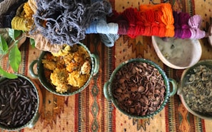 Finished maguey fiber crafts displayed on a wooden table, highlighting their natural colors.