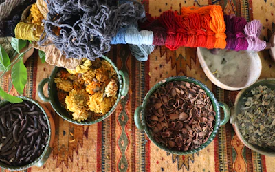 Brightly colored ceramic bowls stacked playfully beside a cozy knit blanket.