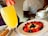 Group of young women enjoying a mimosa breakfast with elegant table setup.