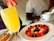 Group of young women enjoying a mimosa breakfast with elegant table setup.