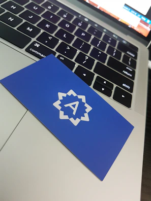 Close-up of a laptop keyboard with a μπλεσπίθα sticker on the corner, highlighting craftsmanship