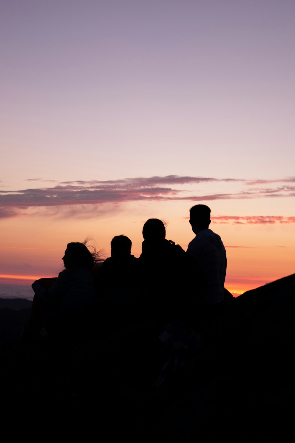 silhouette of people on hill