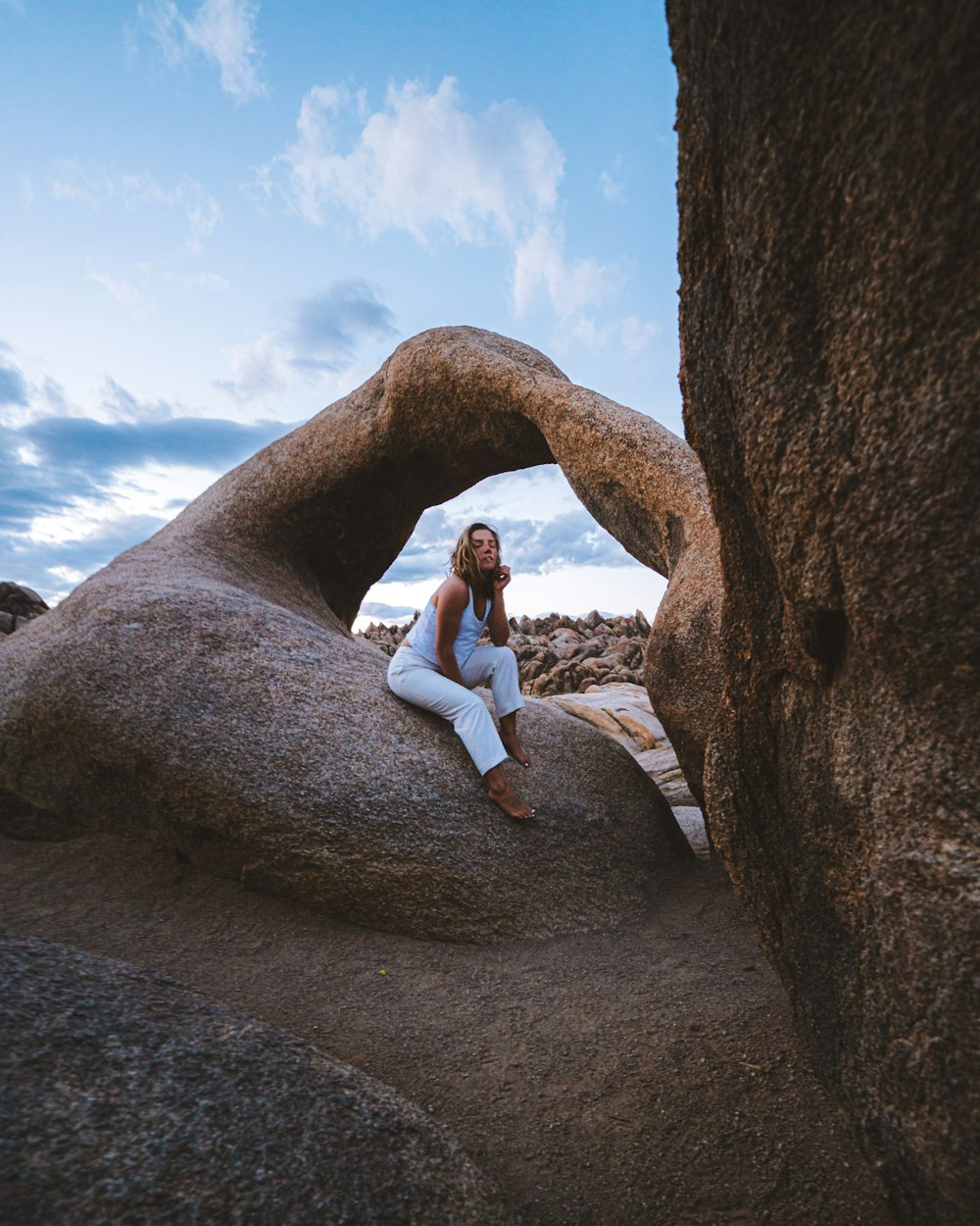 woman sitting on rock