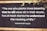 A motivational quote by Rabindranath Tagore is displayed on a dark wooden background with white, bold text. The quote emphasizes the virtue of selflessness and understanding the deeper meaning of life. Parts of green leaves are seen in the top right corner, adding a natural element.