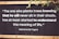 A motivational quote by Rabindranath Tagore is displayed on a dark wooden background with white, bold text. The quote emphasizes the virtue of selflessness and understanding the deeper meaning of life. Parts of green leaves are seen in the top right corner, adding a natural element.