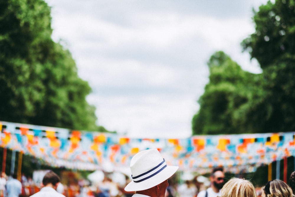 man in white and blue hat in street