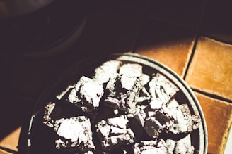 A person enjoying a strong brownie outdoors after a workout, sunlight highlighting the brownie texture.