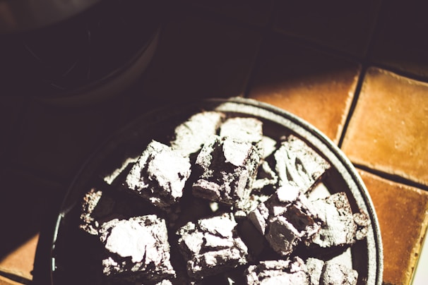 A person enjoying a strong brownie outdoors after a workout, sunlight highlighting the brownie texture.