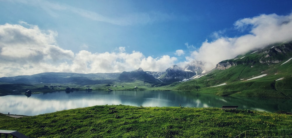 white clouds in blue sky over lake