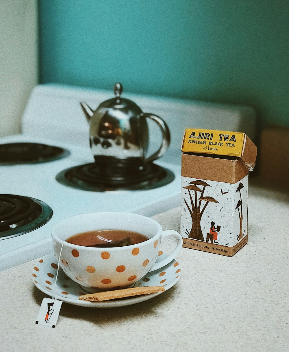 white and brown polka-dot ceramic teacup