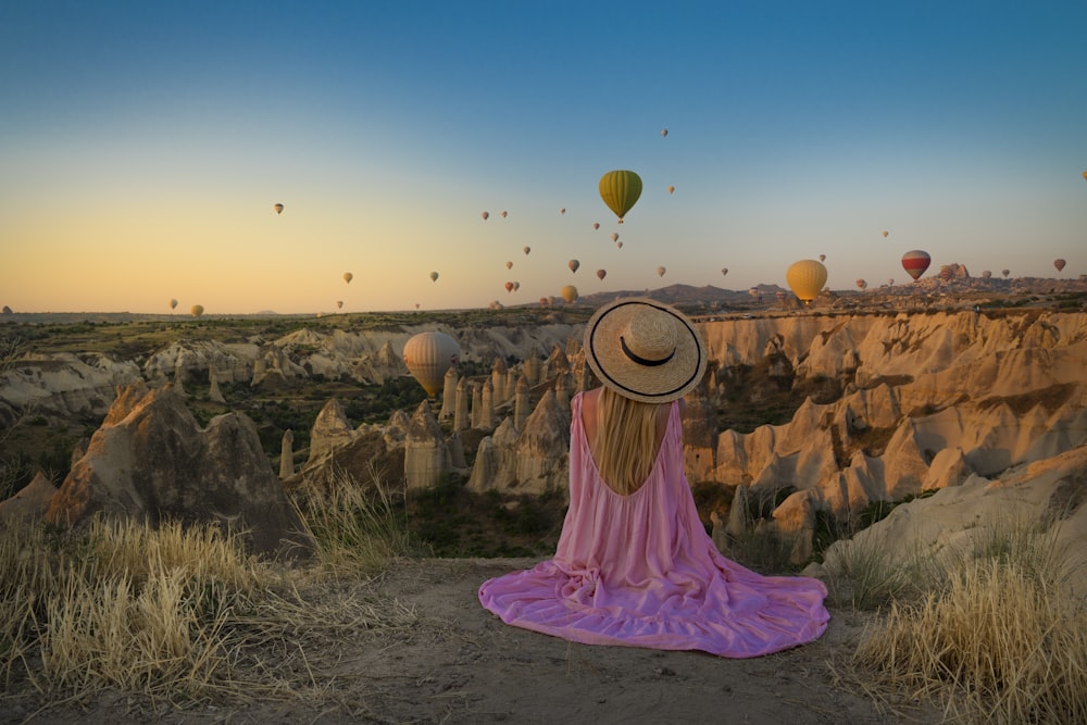 woman sitting near Monument Valley National Park during daytime