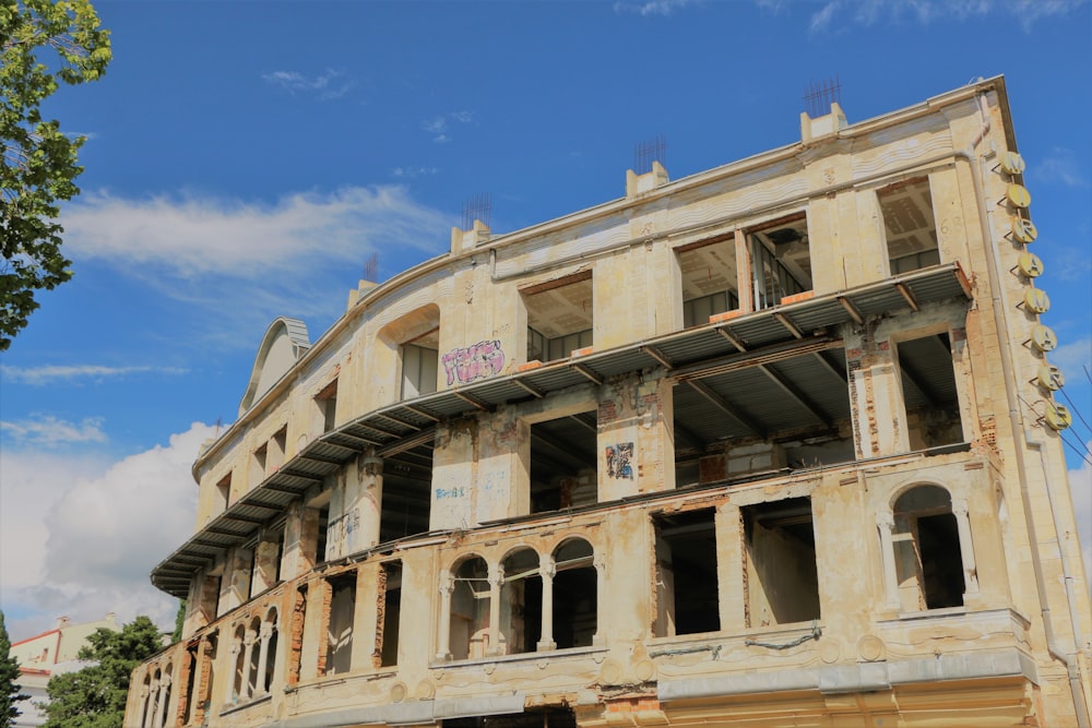 brown concrete building under blue and white skies