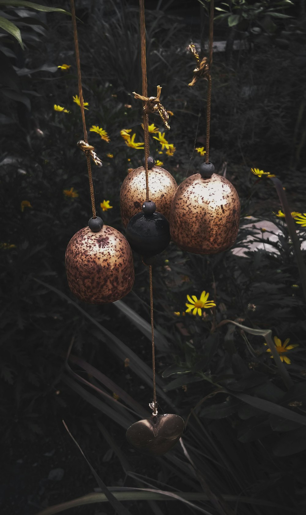 brown pendant wind chimes near plants