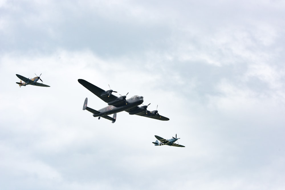 B-24 bomber escorted by two P-51 mustangs