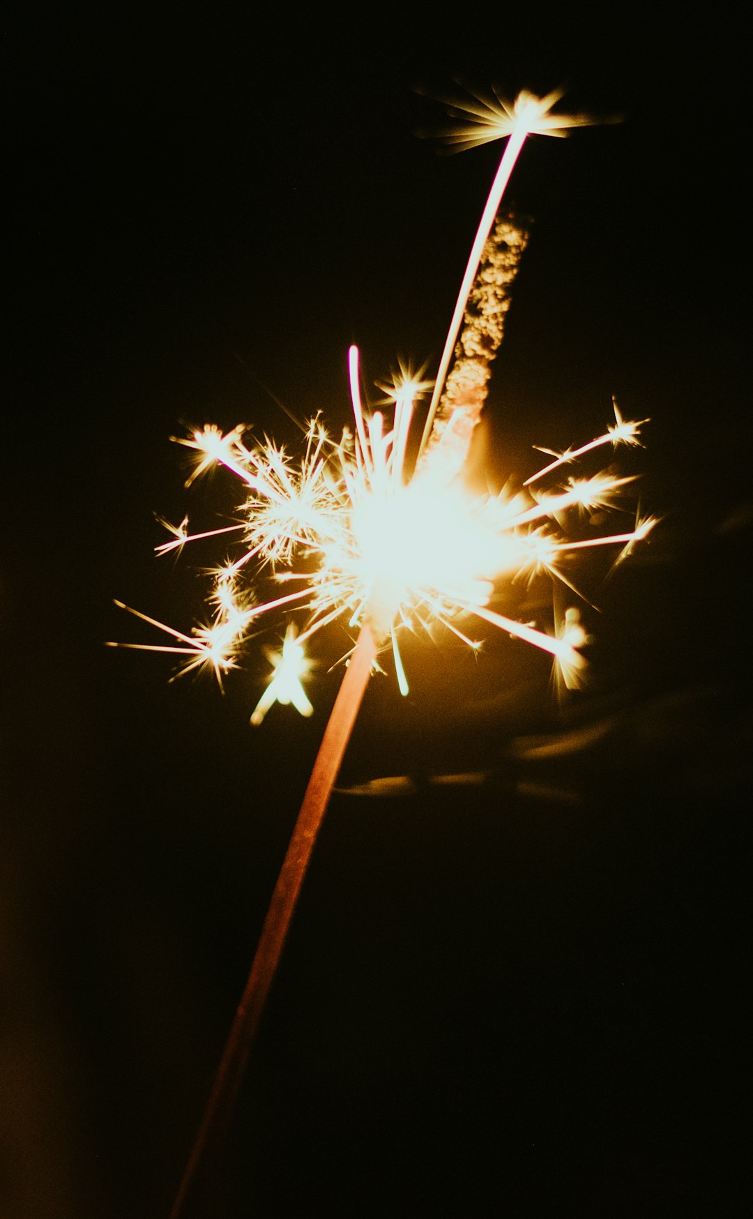 white and yellow sparkler close-up photography