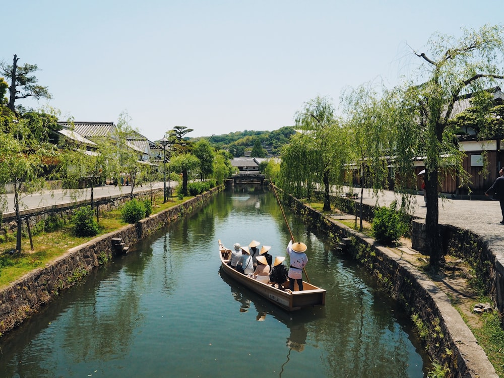 people riding white and brown boat during daytime