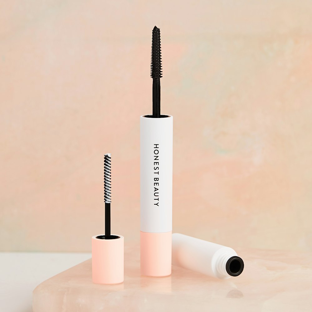 two Honest Beauty mascaras on table