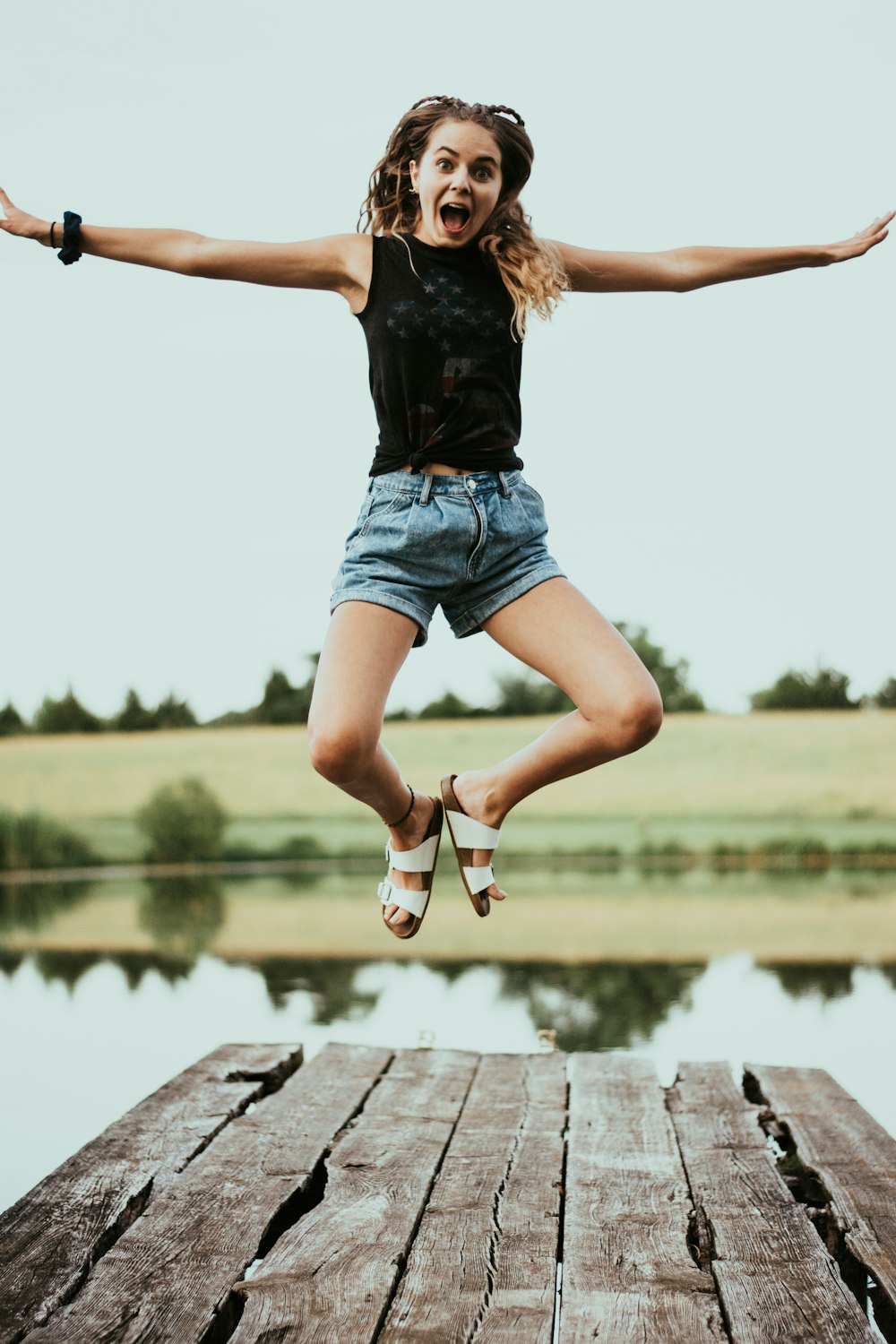 woman jumping on dock