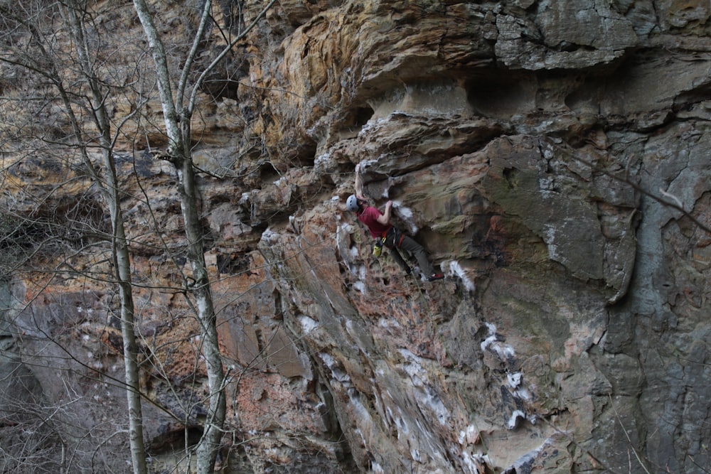 person climbing rocky terrain