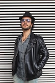 man wearing standing beside wall