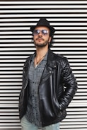 man wearing standing beside wall