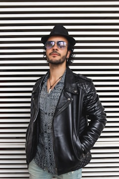 man wearing standing beside wall