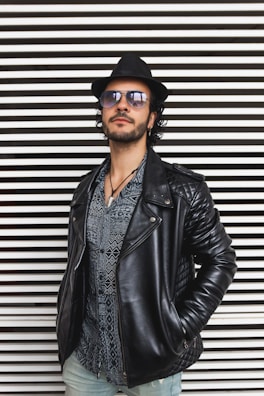 man wearing standing beside wall