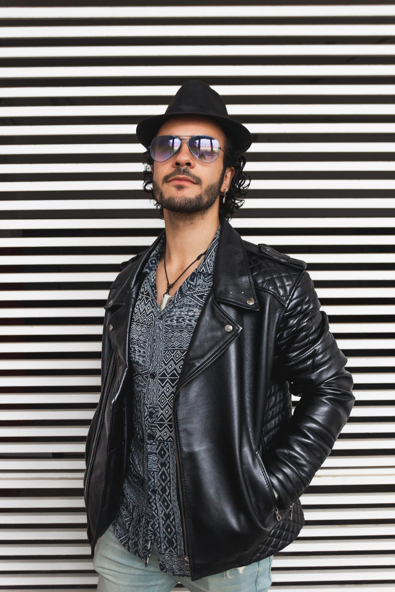 Man in black leather biker jacket and hat