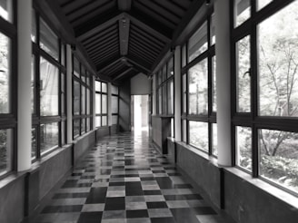 Clean and hygienic clinic corridor with natural light streaming through large windows.