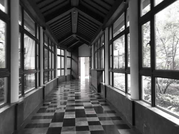 Clean and hygienic clinic corridor with natural light streaming through large windows.