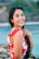 woman wearing white and red floral top across body of water