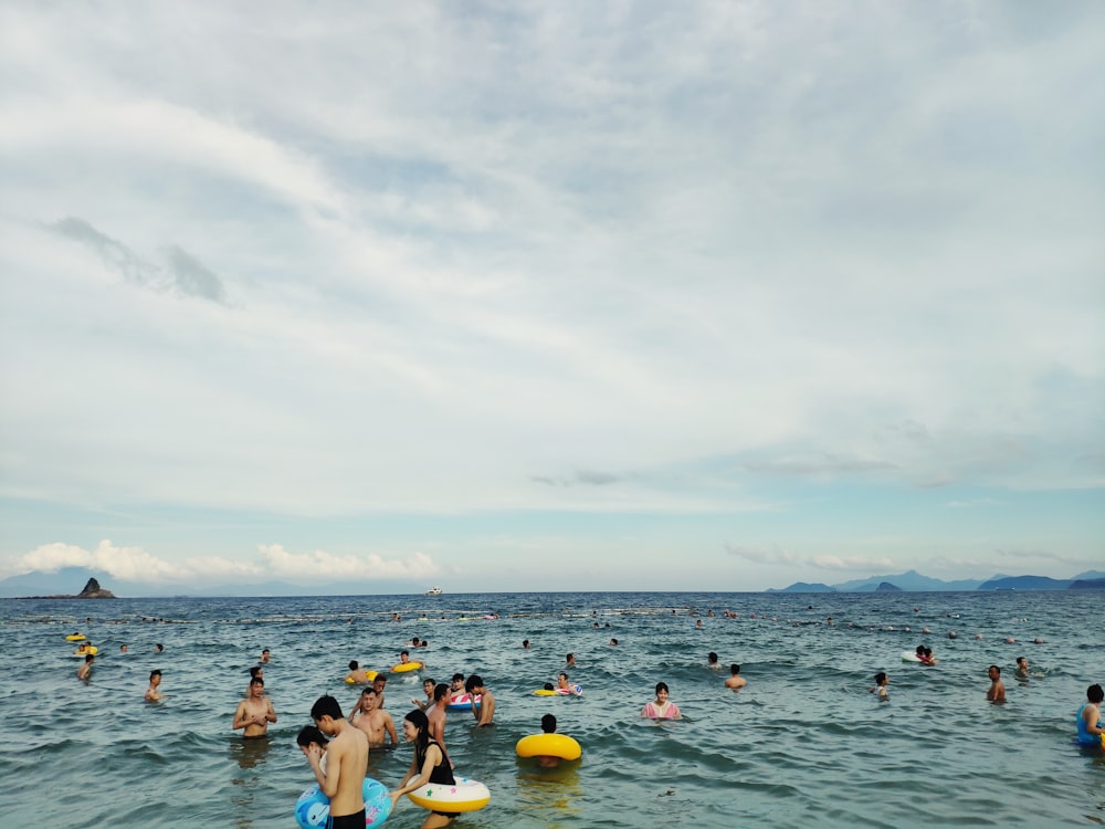 people swimming on sea