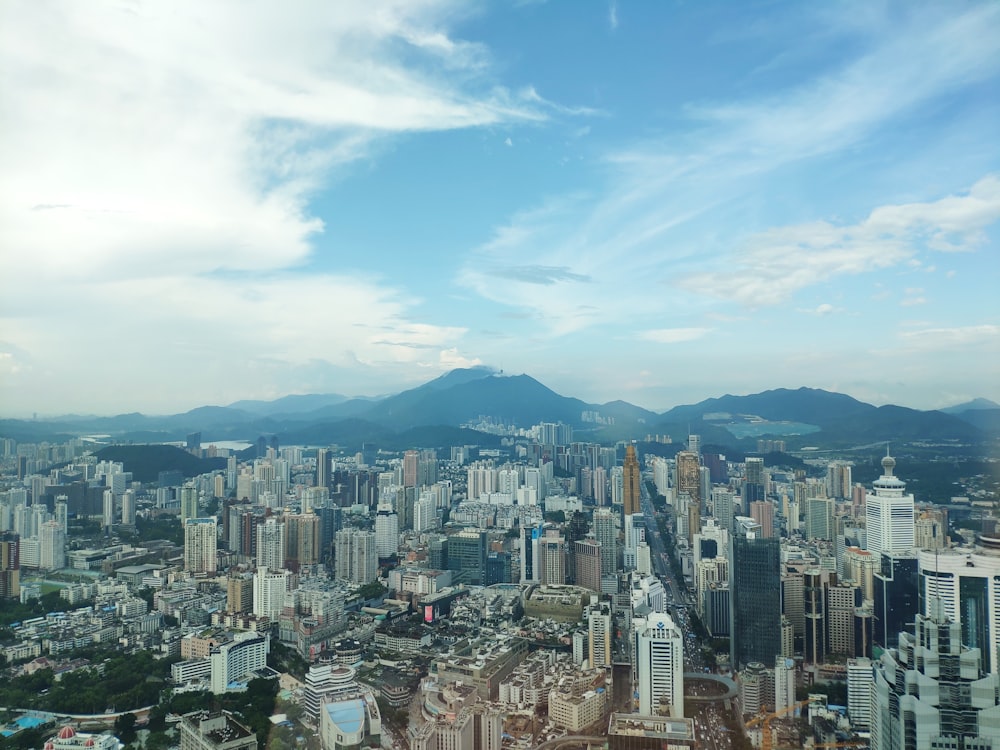 white clouds above high rise buildings