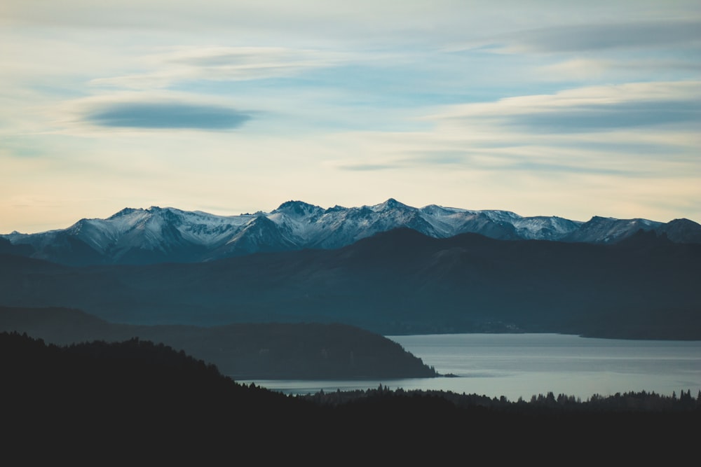 trees, lake, and mountains during day