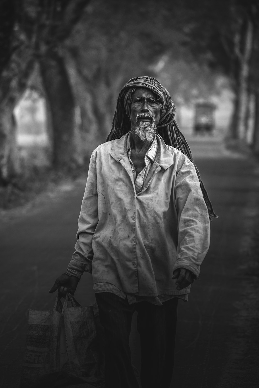 man walking while carrying bag