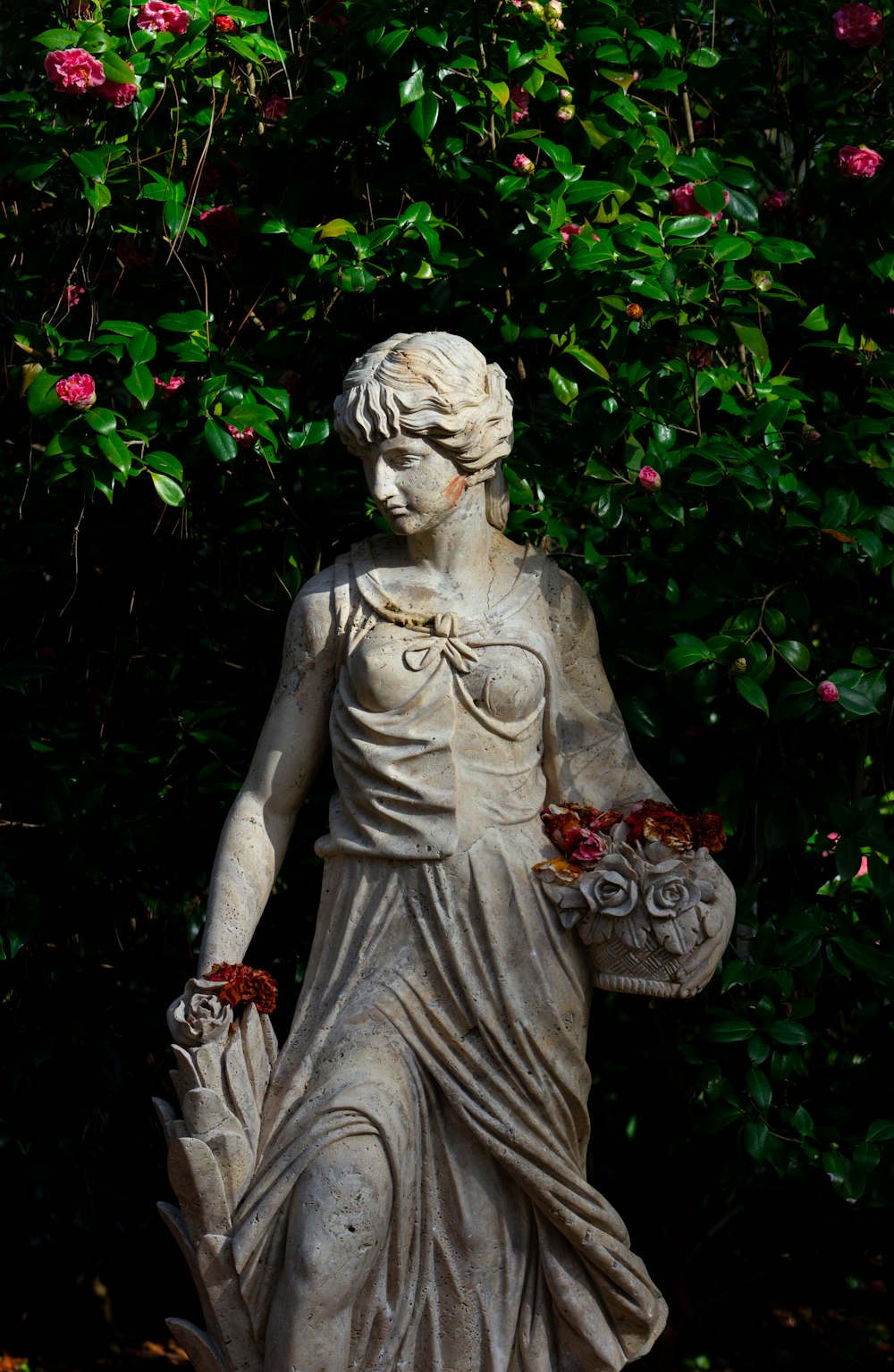 woman holding basket statue