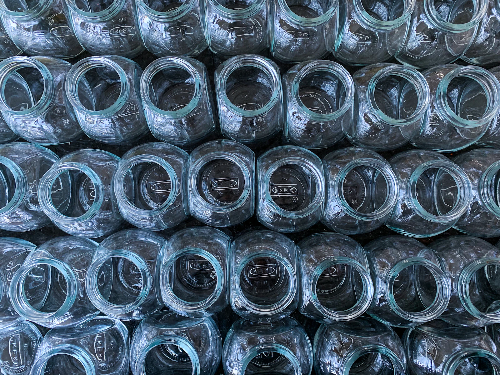 A group of clear glass jars ready to be filled. Photo by Rob Sheahan on Unsplash.