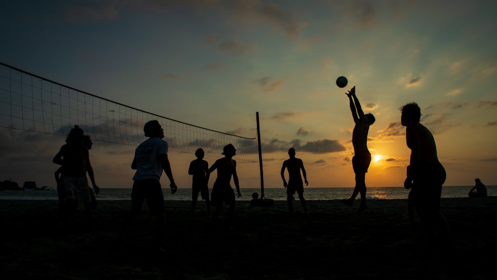 silhouette of people playing volleyball