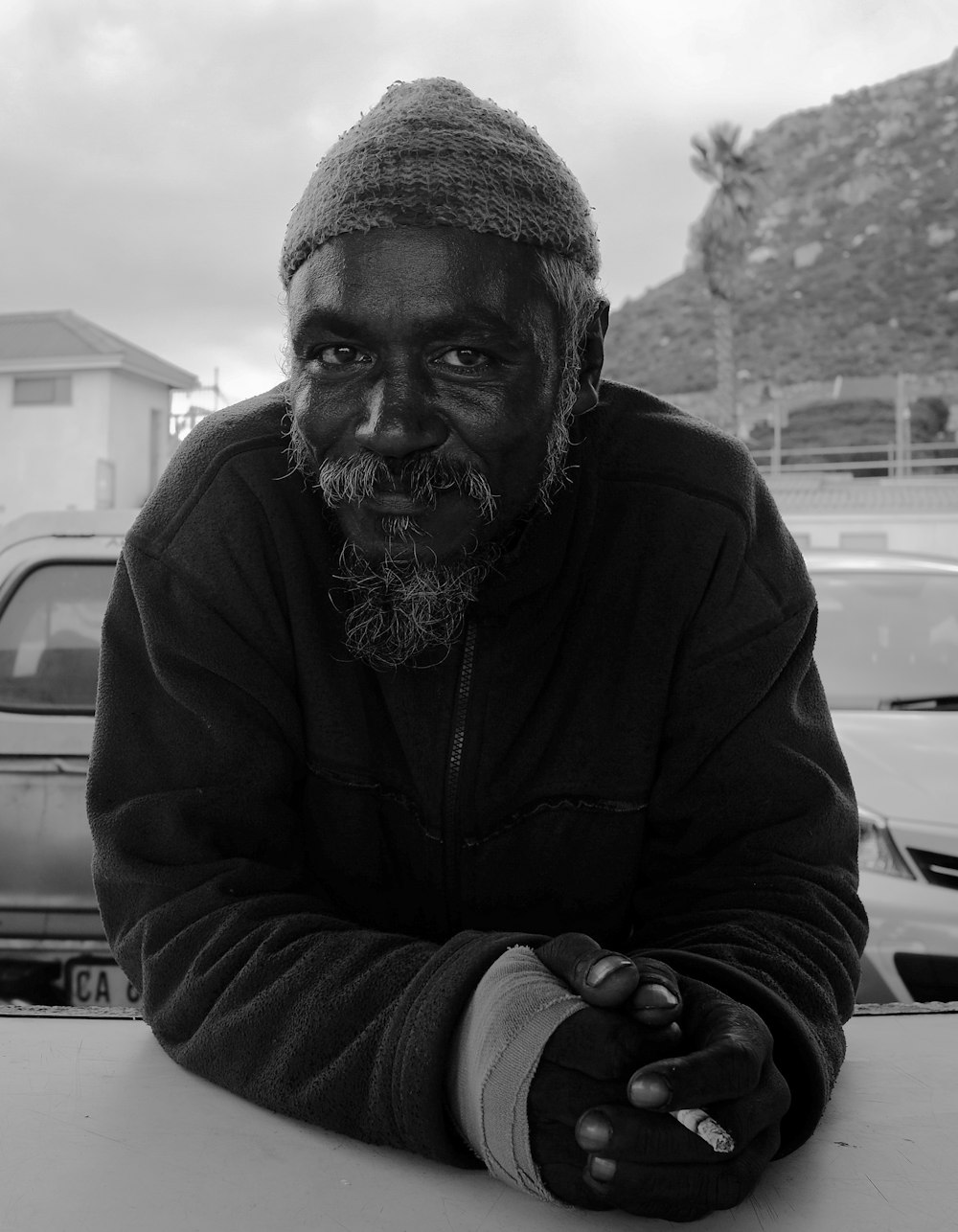 grayscale photography of man wearing jacket