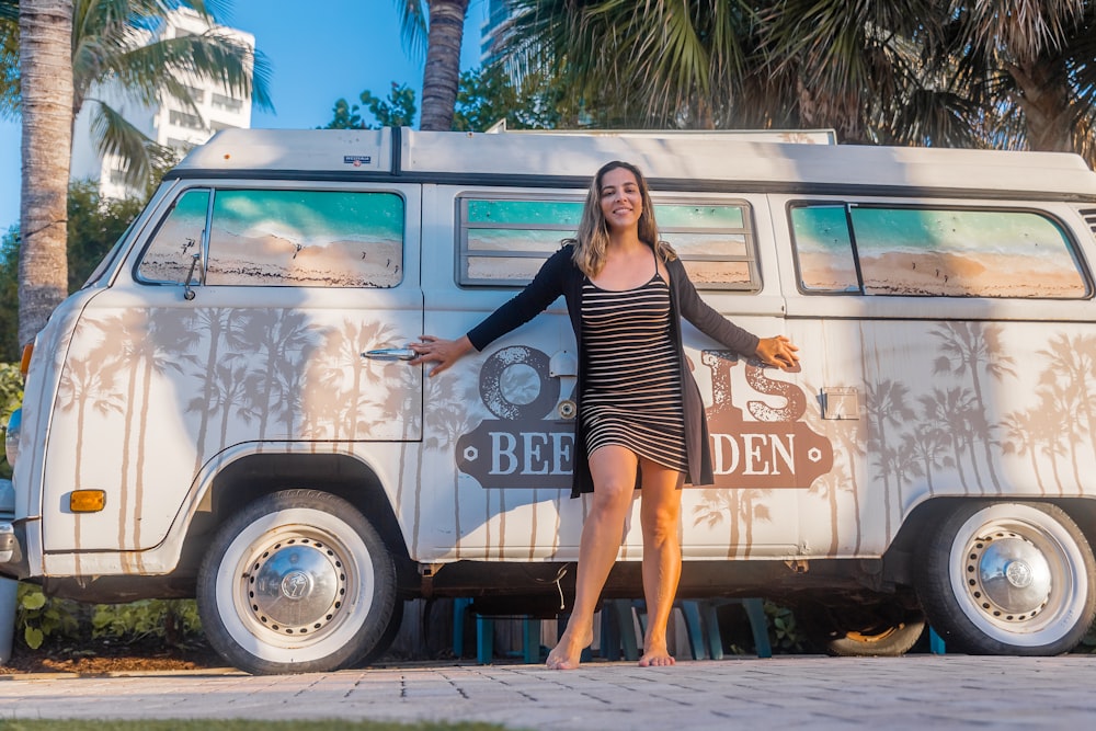 smiling woman standing beside van during daytime