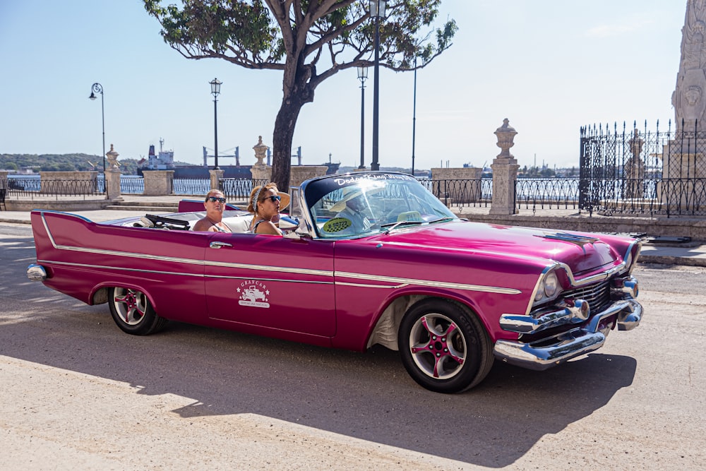 people riding on purple coupe