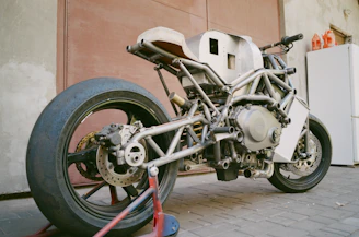 A close-up of a partially assembled custom motorcycle frame in the workshop.