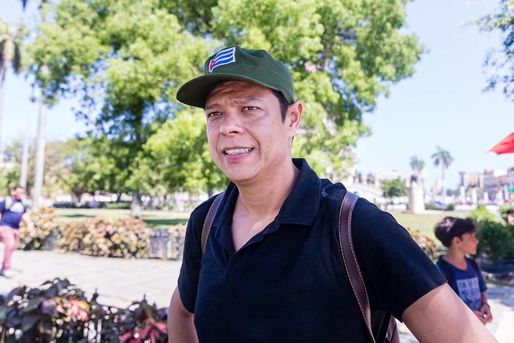 men wearing a green cap during daytime