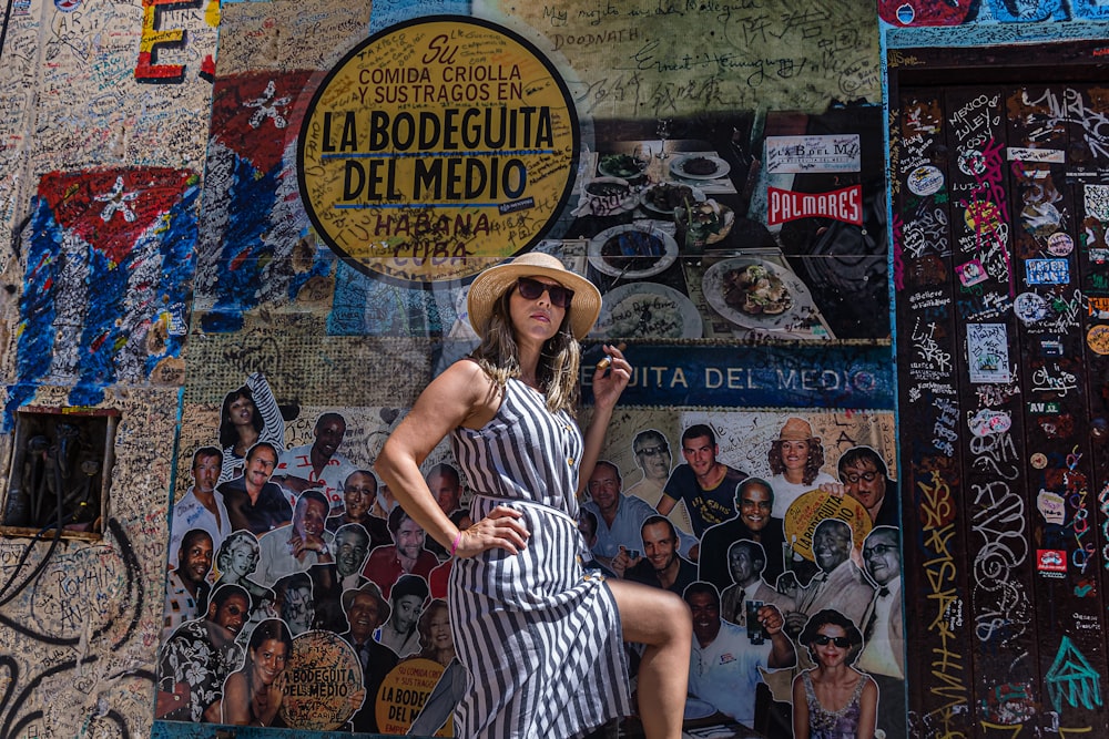 women near a painted wall during daytime