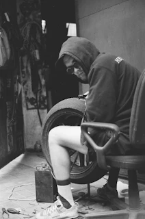 Close-up of a skilled technician repairing a car tire in a bright workshop