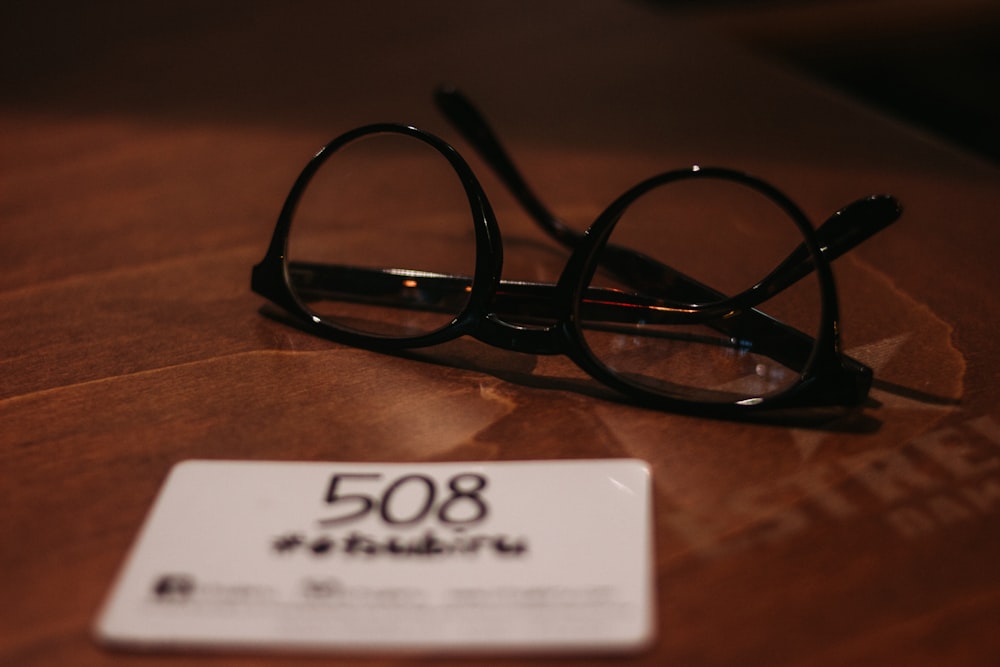 black framed eyeglasses on table
