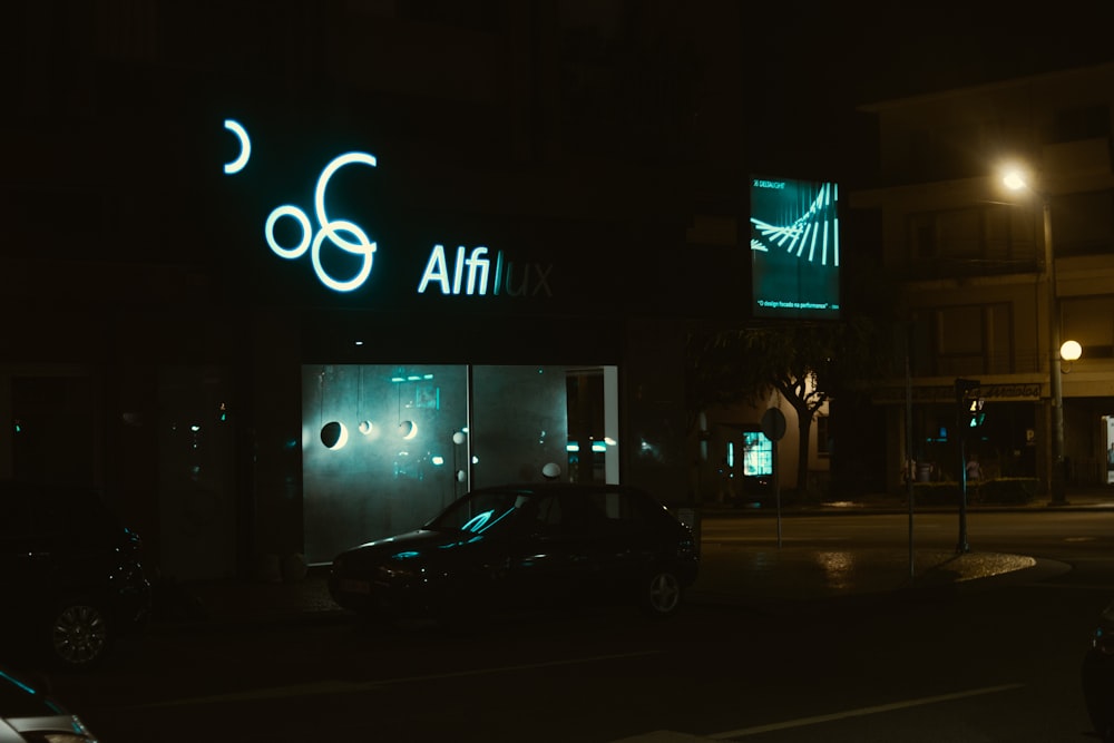 a car parked in front of a building at night