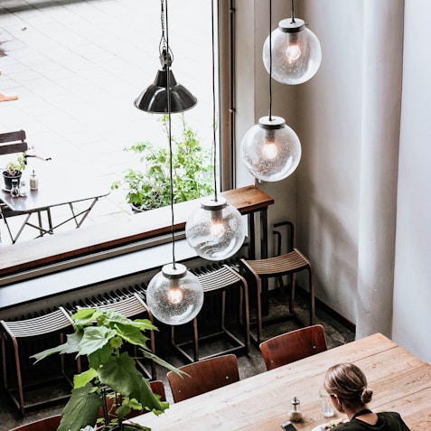 woman in black shirt sitting by the table